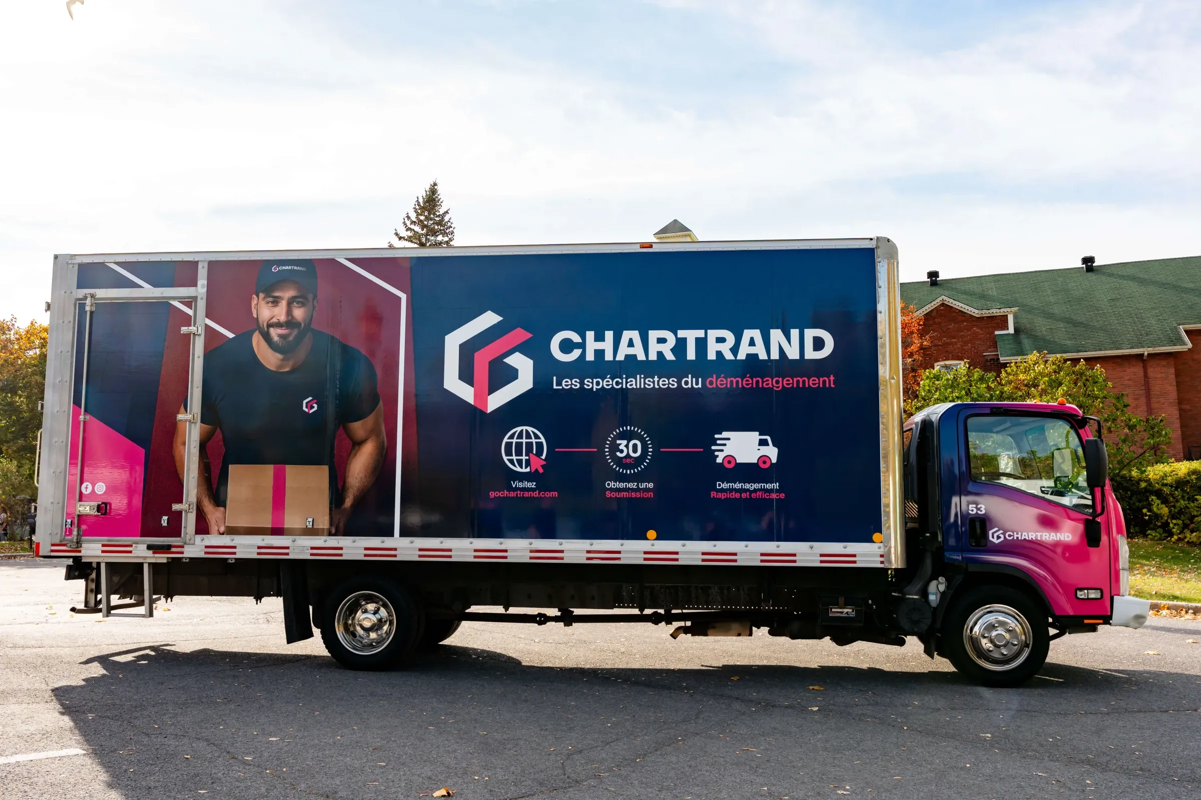 Chartrand truck seen from the side in front of trees in autumn colours