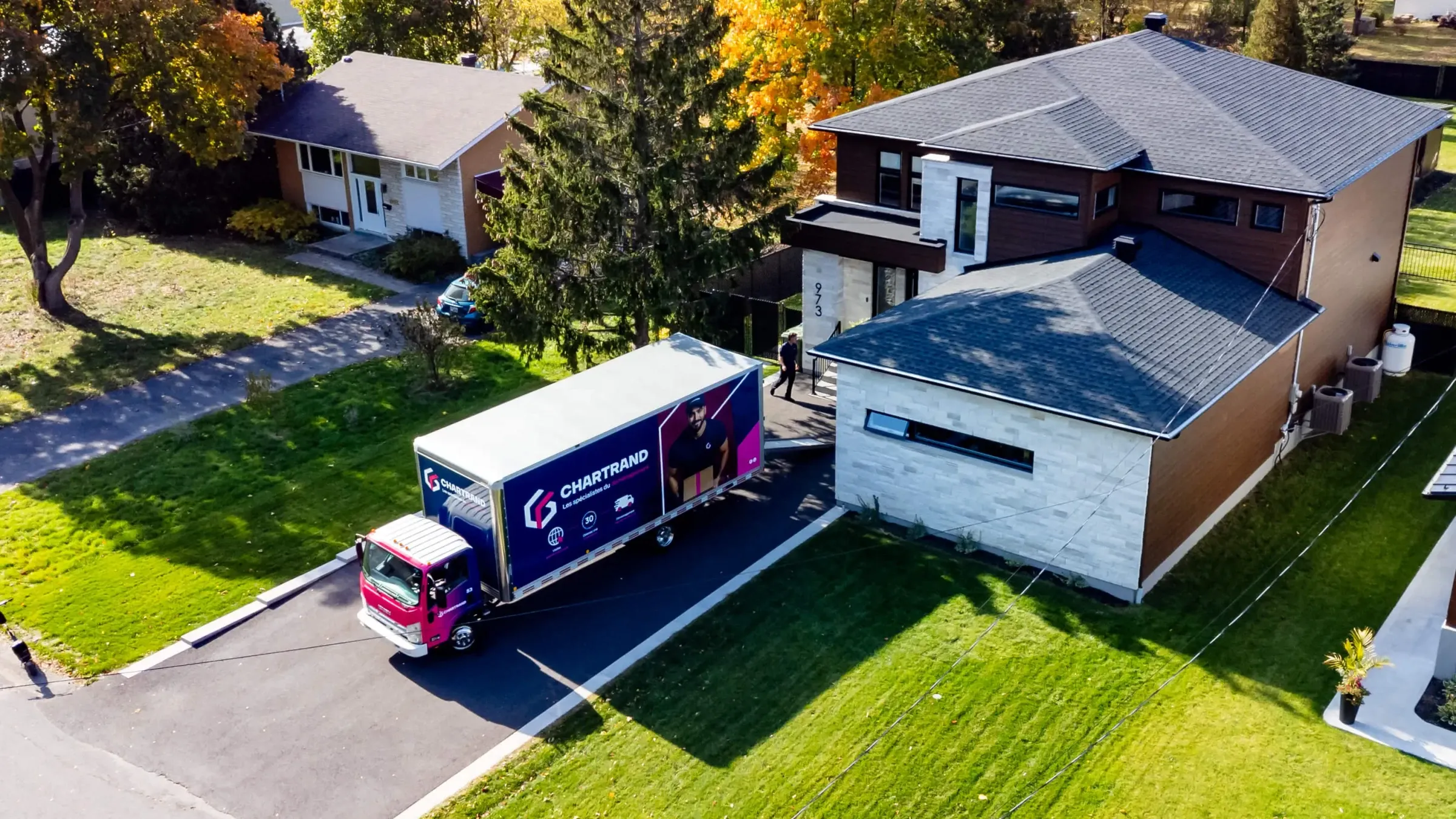 Aerial view of a Chartrand truck in the driveway of a suburban home