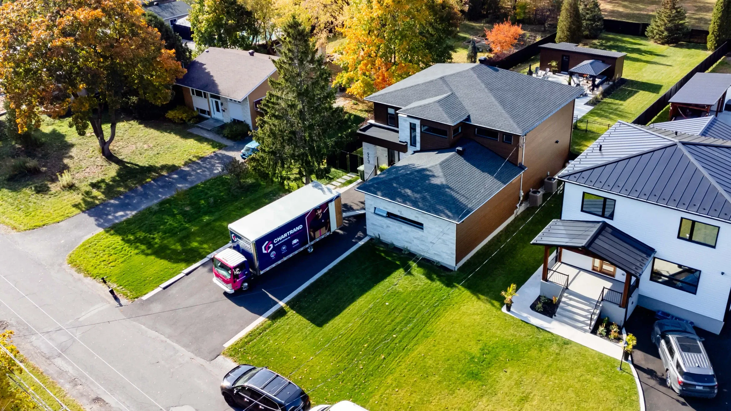 Aerial view of a Chartrand truck parked in front of a suburban house