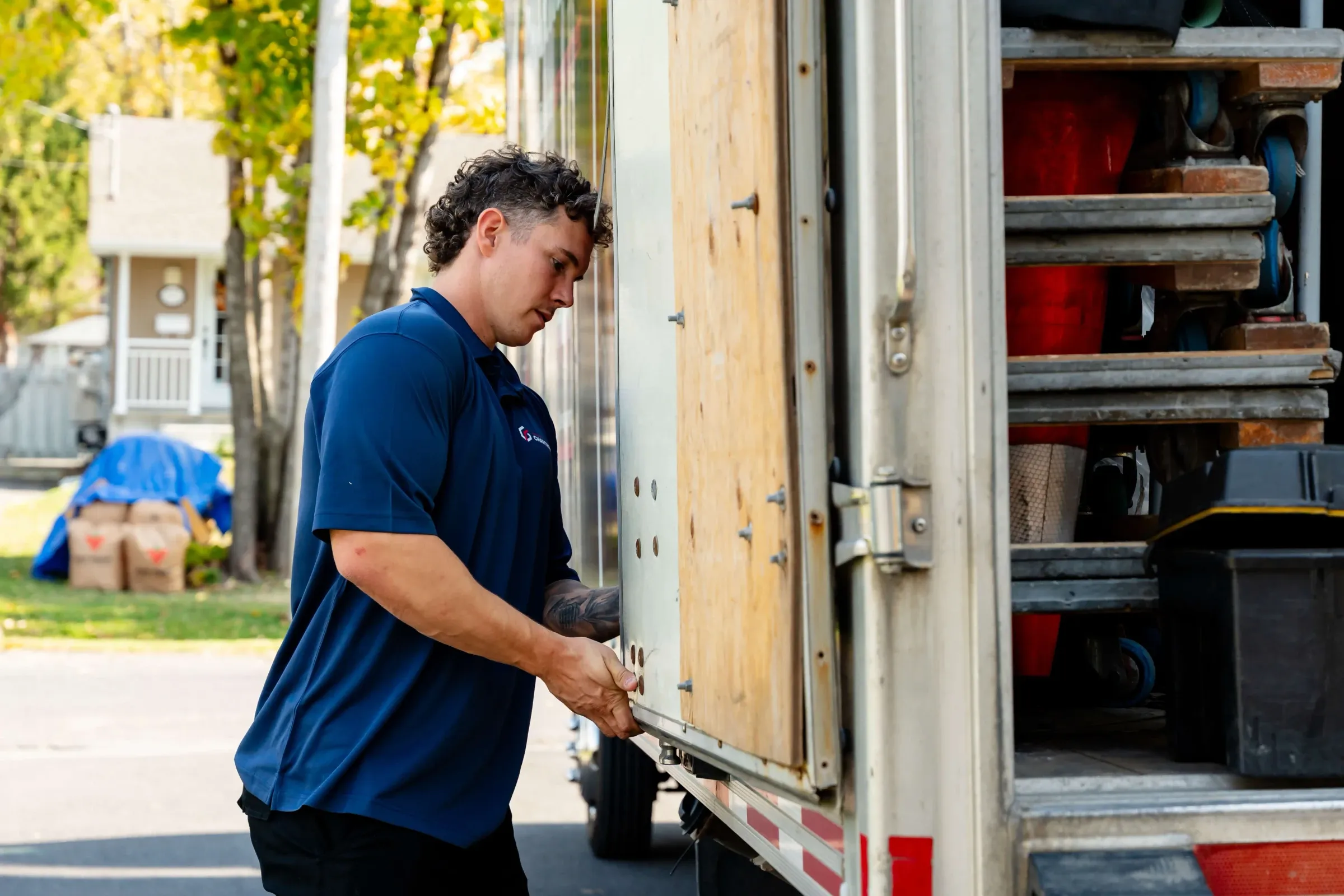 Chartrand mover opening the side door of a truck filled with equipment