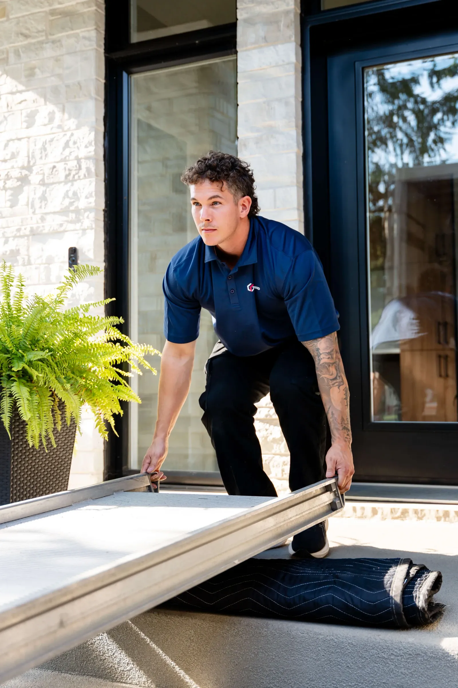 Chartrand mover placing a ramp at the front door of a house