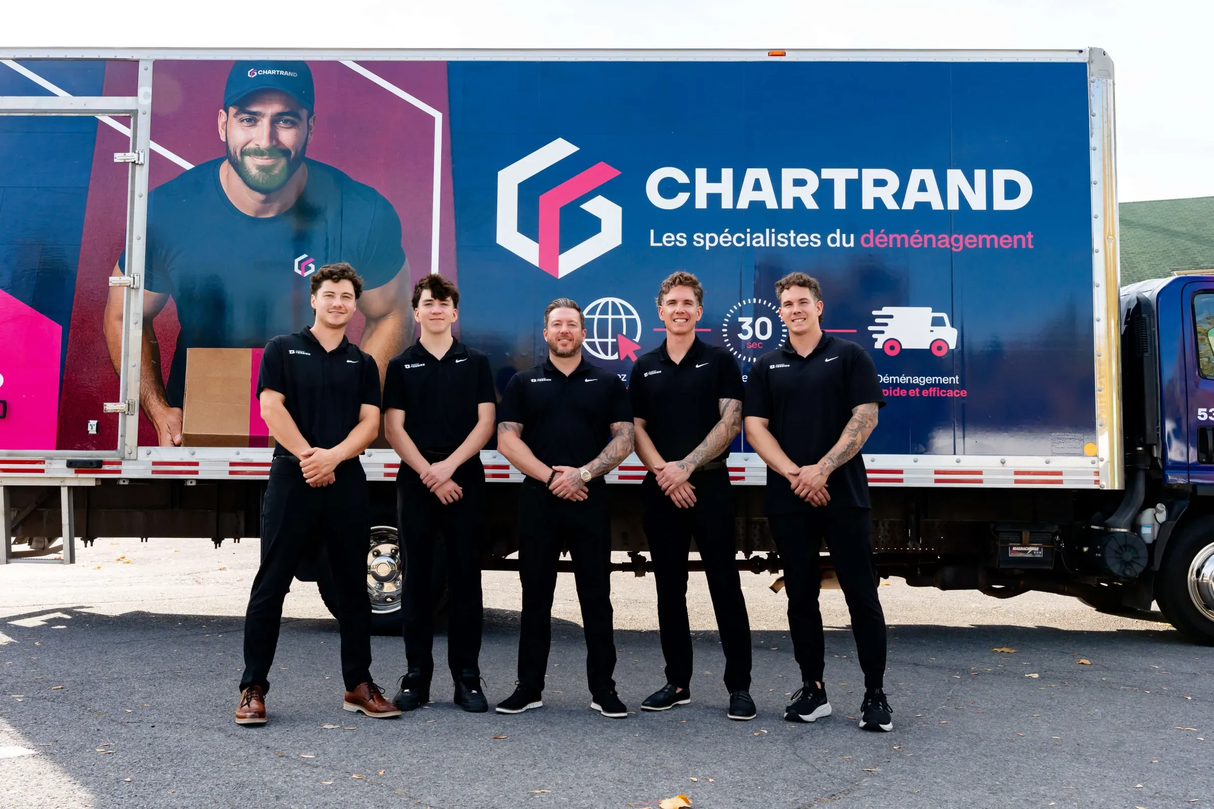Team of five Chartrand movers in front of a fleet truck
