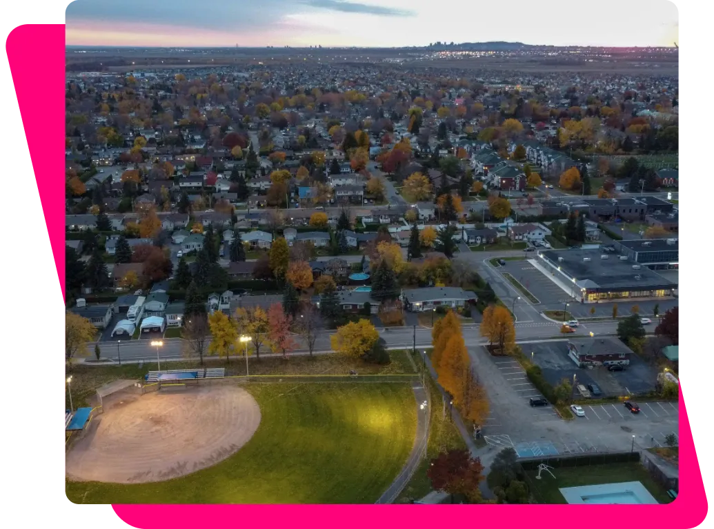 Aerial view of a residential neighbourhood and a park in Sainte-Julie at dusk